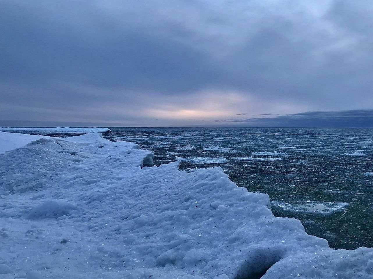 Frozen lake at sunrise, safe ice thickness visible