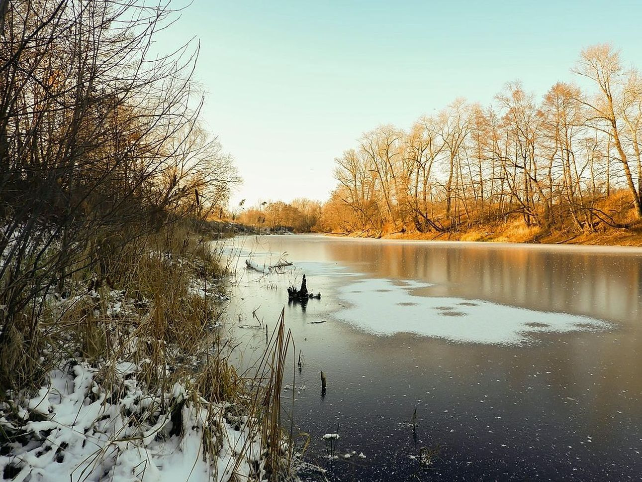 Ice auger and fishing gear ready on ice